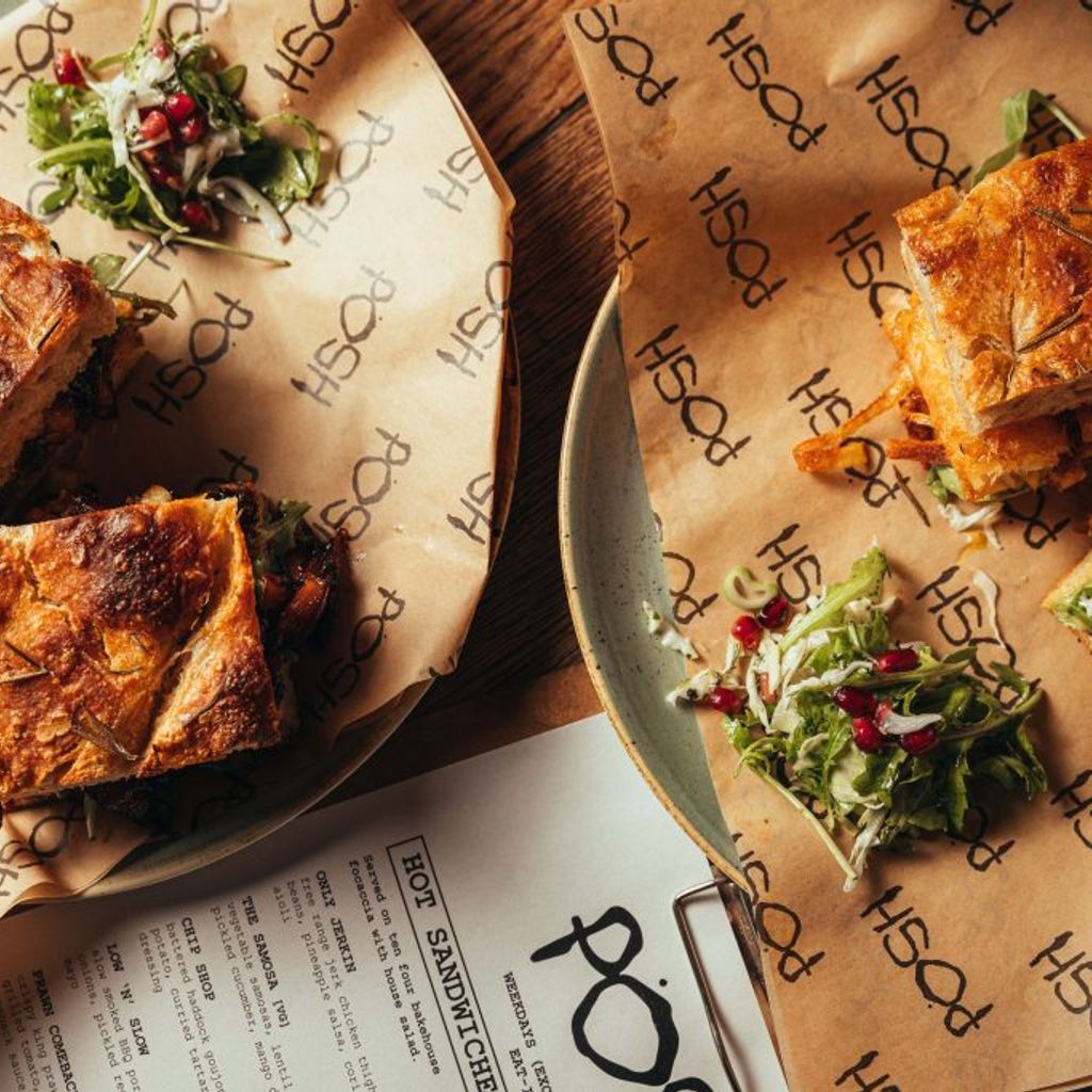 Two large sandwiches on two plates