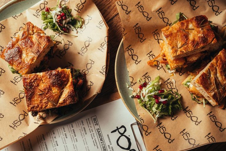 Two large sandwiches on two plates